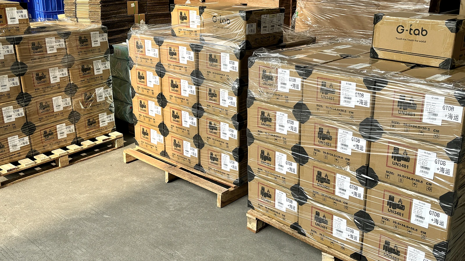 Palletized G-Tab branded cartons prepared for battery-goods export shipment