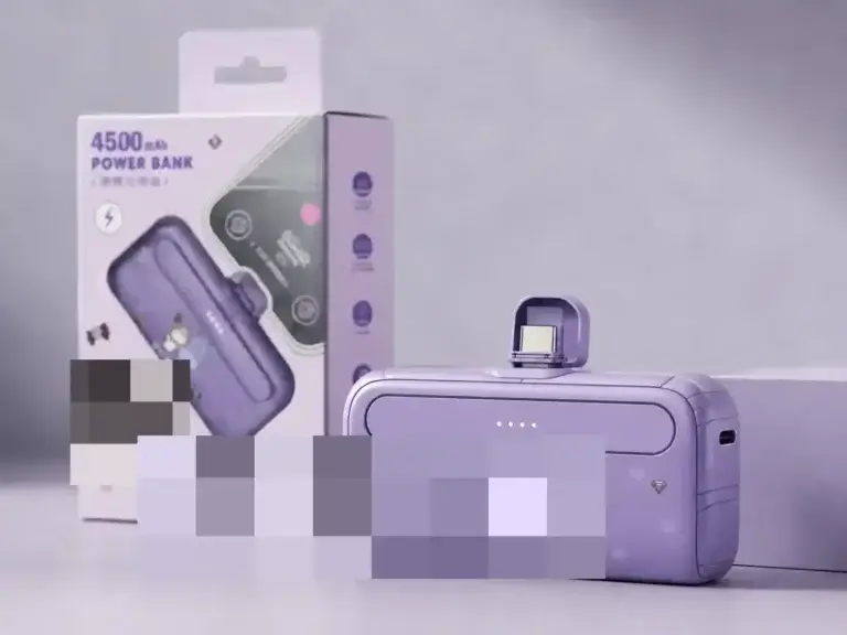 F69 purple direct-plug power bank and retail packaging with brand artwork obscured